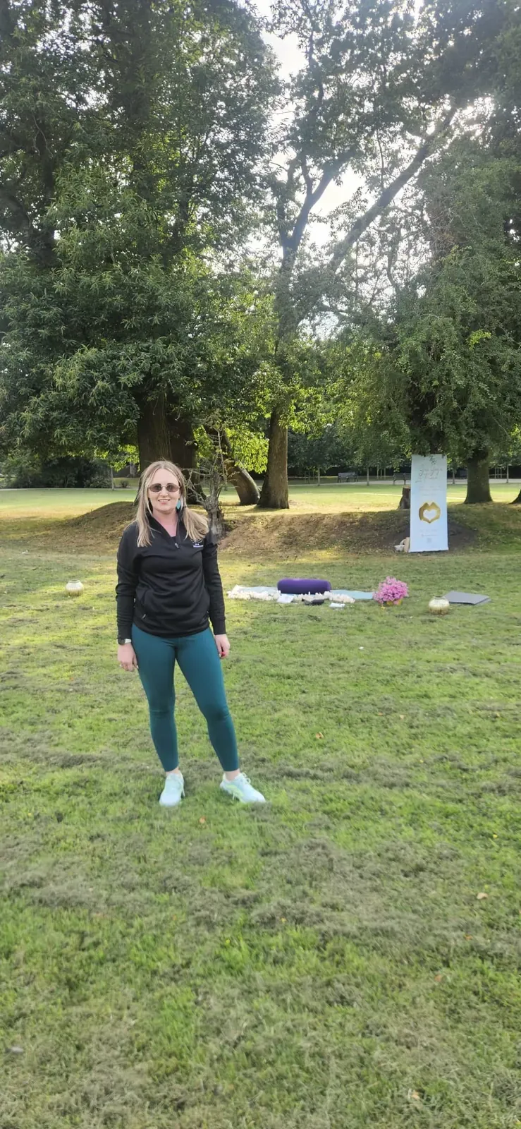 Fiona Mullen of Grá Wellness in a park in Meath, beside a Grá Wellness banner set up for an outdoor event